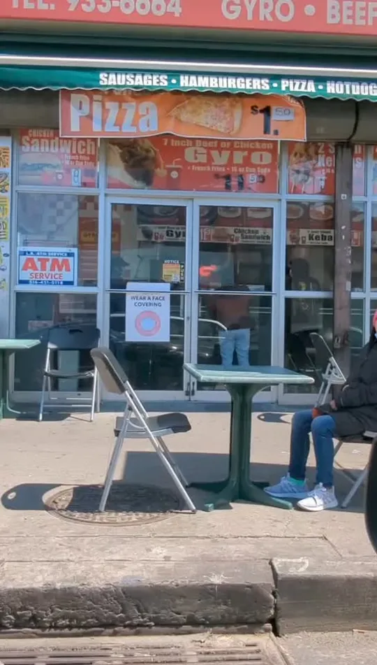 The Gyro King storefront with its sidewalk tables and menu posters
