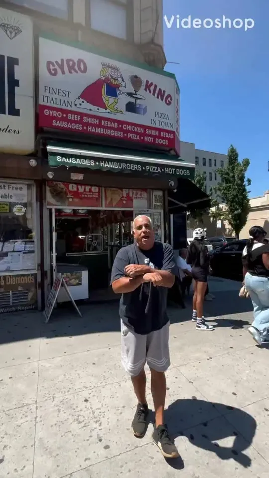 A regular standing outside the Gyro King storefront under its sign