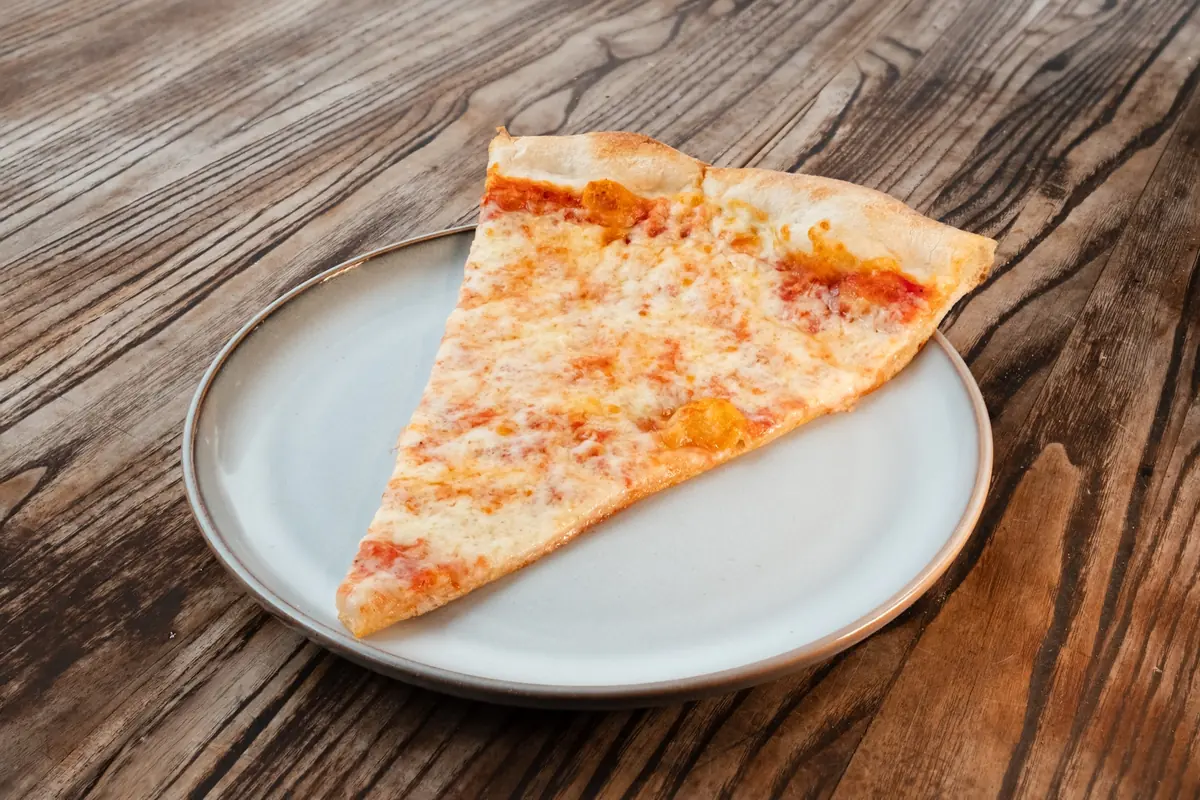Cheese pizza slice on a plate