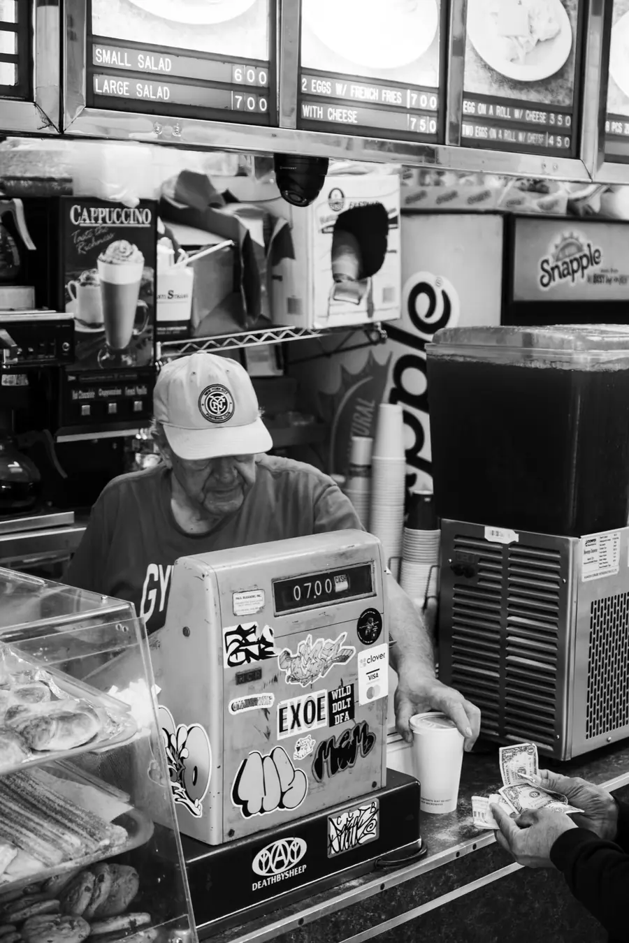The vintage cash register at the counter, in black and white