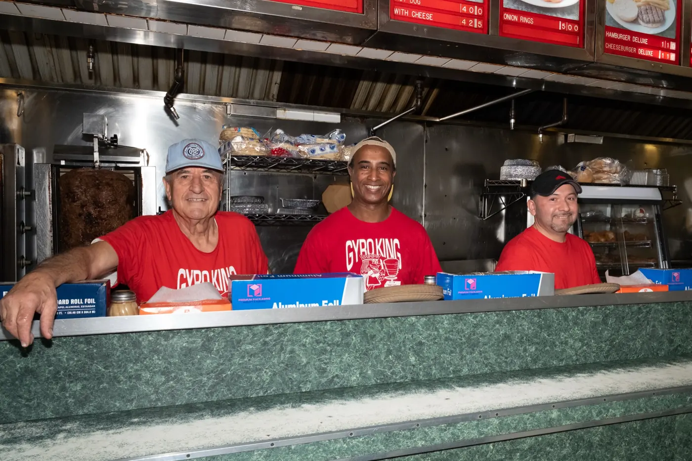 The Gyro King crew lined up behind the counter in red shirts