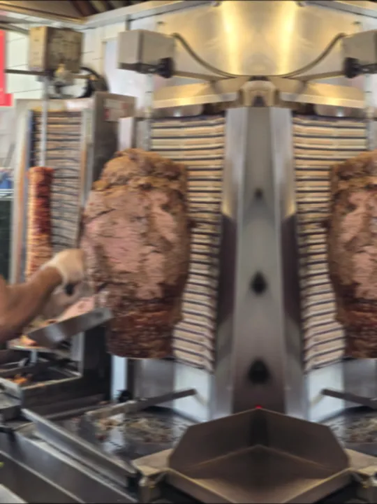 Gyro meat turning on the vertical rotisserie